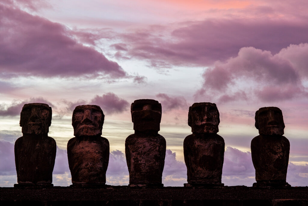 Moai of Easter Island (Rapa Nui) during a colorful sunrise.