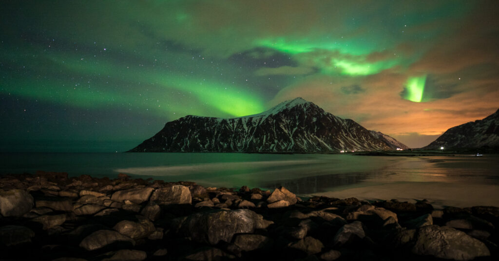 A photograph of the Aurora Borealis around the Lofoten Islands.
